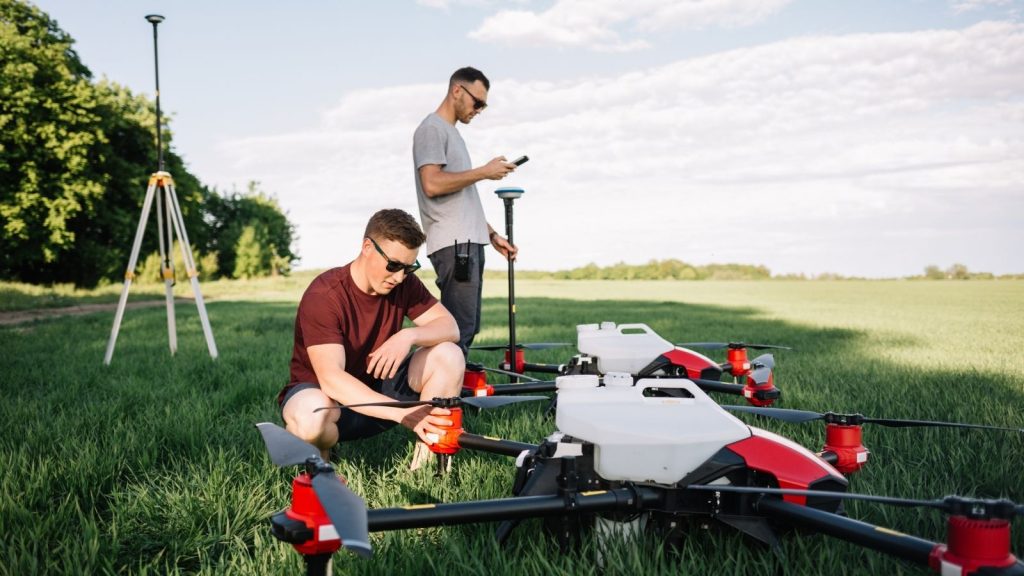 Team of drone operators in training, setting up equipment in the field